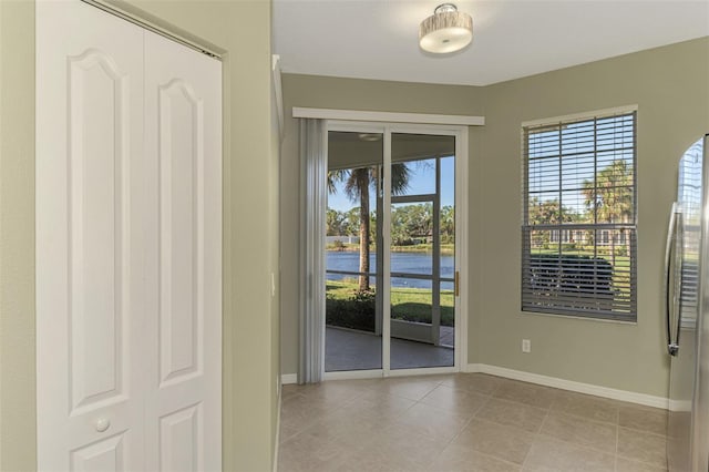 doorway to outside with light tile patterned flooring