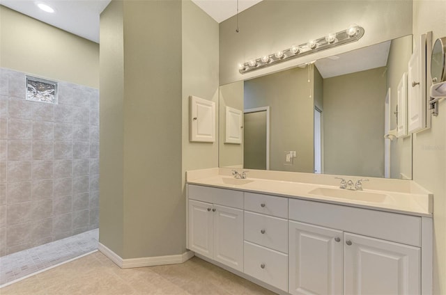 bathroom featuring walk in shower, tile patterned floors, and vanity