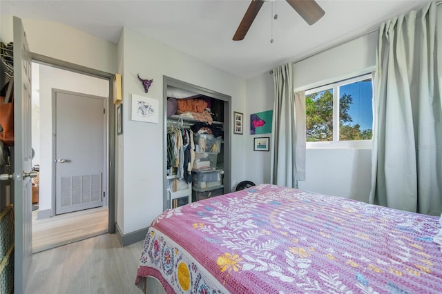 bedroom with ceiling fan, a closet, and light hardwood / wood-style flooring