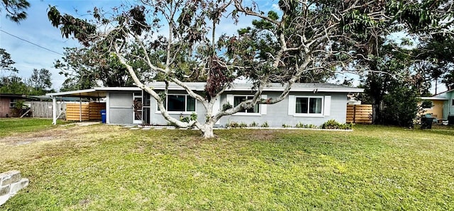 back of house with a lawn and a carport