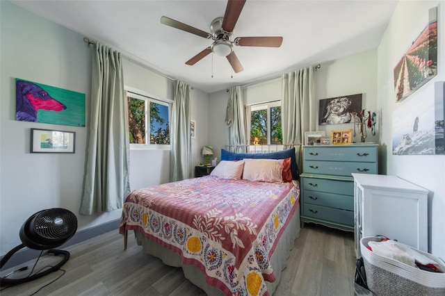 bedroom with ceiling fan and hardwood / wood-style flooring