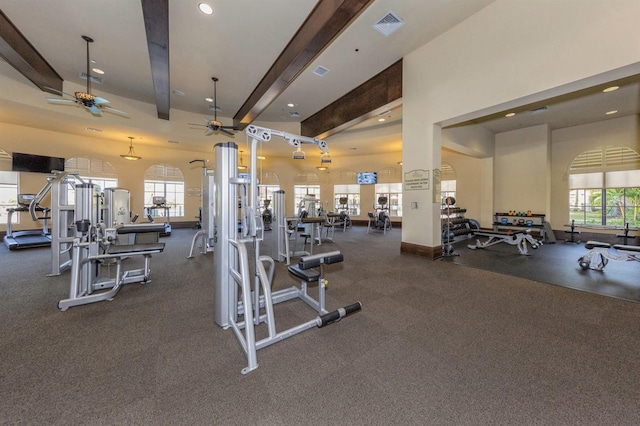 workout area with ceiling fan and a high ceiling