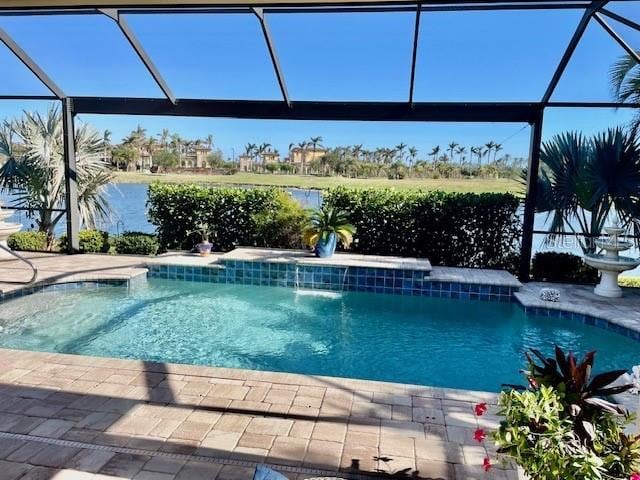 view of swimming pool with glass enclosure and a patio