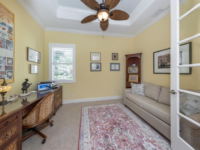 office area featuring a tray ceiling, crown molding, light tile patterned floors, and ceiling fan