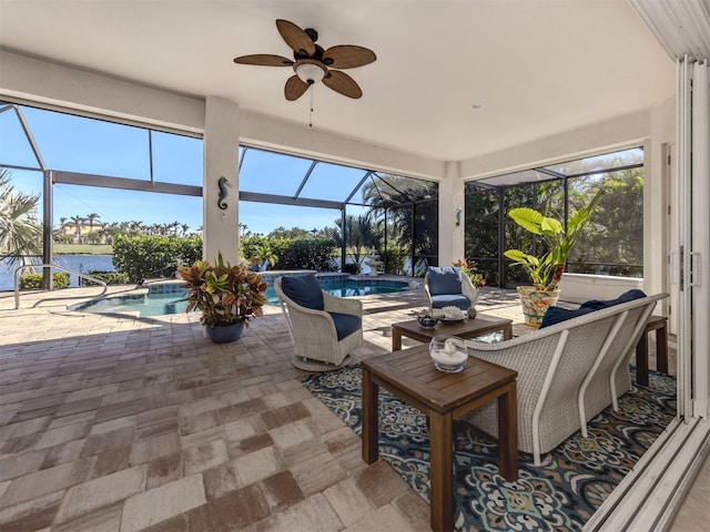 sunroom / solarium with ceiling fan, a water view, and a pool