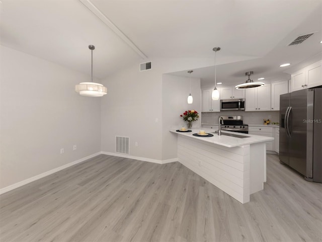 kitchen featuring white cabinetry, light hardwood / wood-style flooring, kitchen peninsula, pendant lighting, and appliances with stainless steel finishes