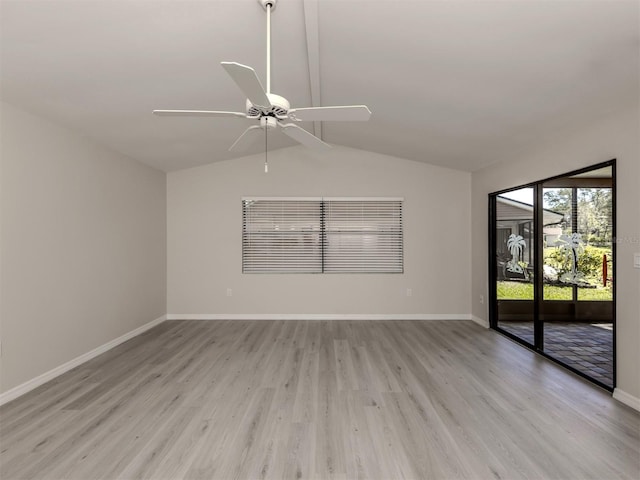 spare room with light hardwood / wood-style floors, vaulted ceiling, and ceiling fan