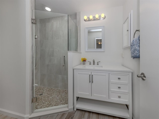 bathroom featuring vanity, hardwood / wood-style flooring, and an enclosed shower