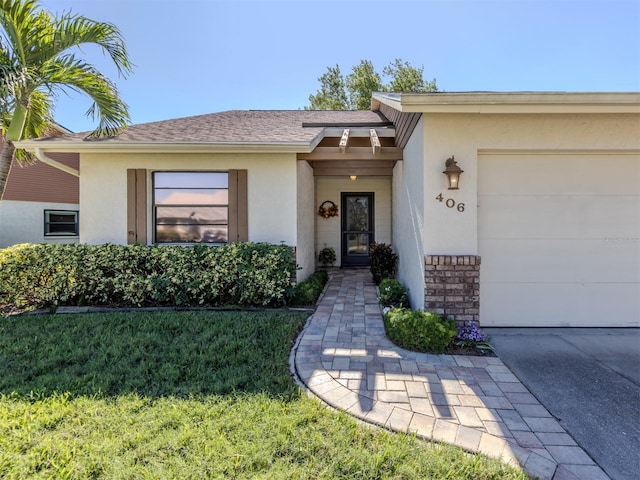 property entrance featuring a yard and a garage