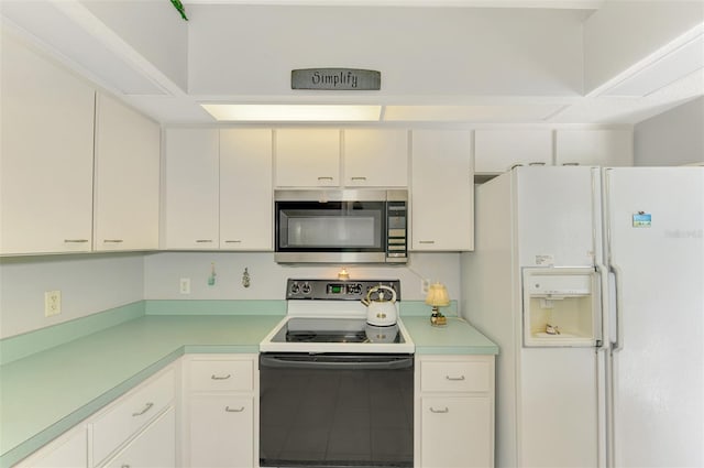 kitchen with electric stove, white cabinets, and white refrigerator with ice dispenser