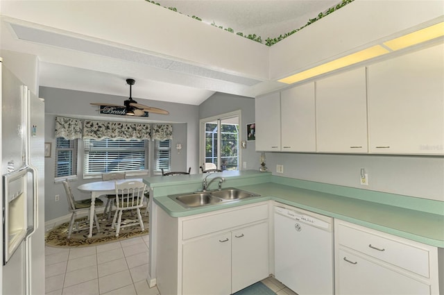 kitchen with white cabinets, dishwasher, kitchen peninsula, and sink