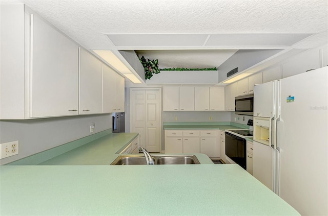 kitchen with sink, white refrigerator with ice dispenser, range with electric stovetop, kitchen peninsula, and a textured ceiling