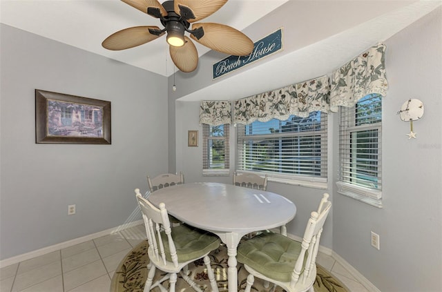 tiled dining area with ceiling fan