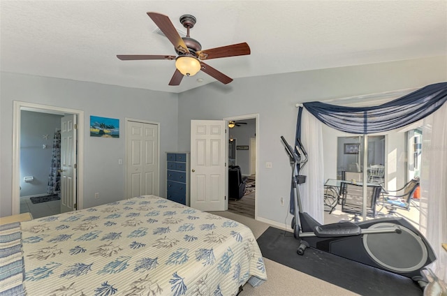 carpeted bedroom with ensuite bathroom, a textured ceiling, vaulted ceiling, ceiling fan, and a closet