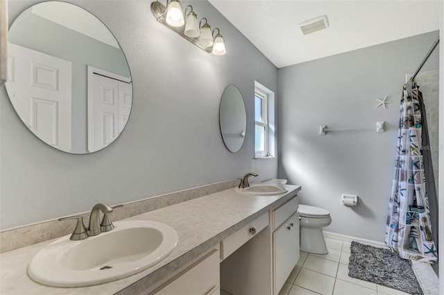 bathroom featuring tile patterned flooring, vanity, a shower with shower curtain, and toilet