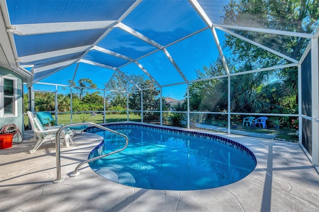 view of swimming pool with a patio and glass enclosure