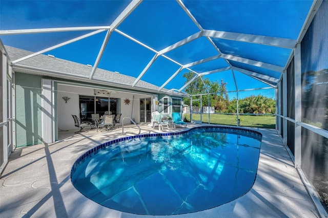 view of swimming pool featuring a lanai, a patio area, ceiling fan, and a lawn