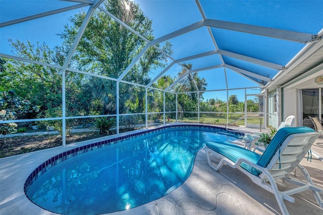 view of swimming pool with a patio and a lanai