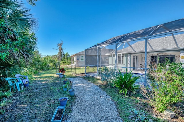 view of yard featuring a lanai