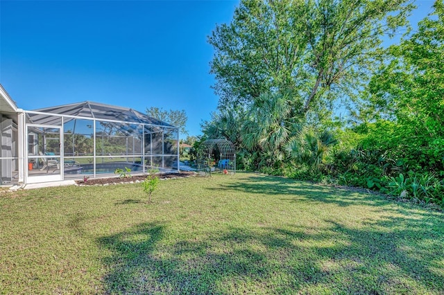 view of yard with glass enclosure