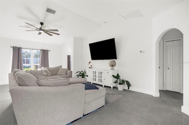 tiled living room with ceiling fan and vaulted ceiling