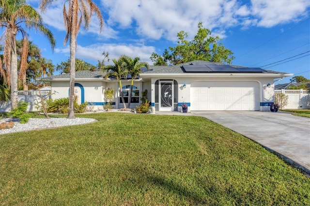 single story home featuring a front yard, solar panels, and a garage