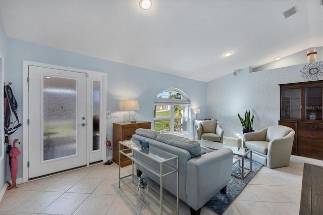 living room featuring lofted ceiling and light tile patterned floors