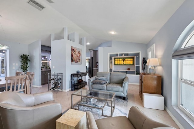 tiled living room featuring vaulted ceiling