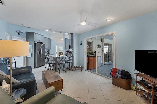 living room with ceiling fan and light tile patterned floors