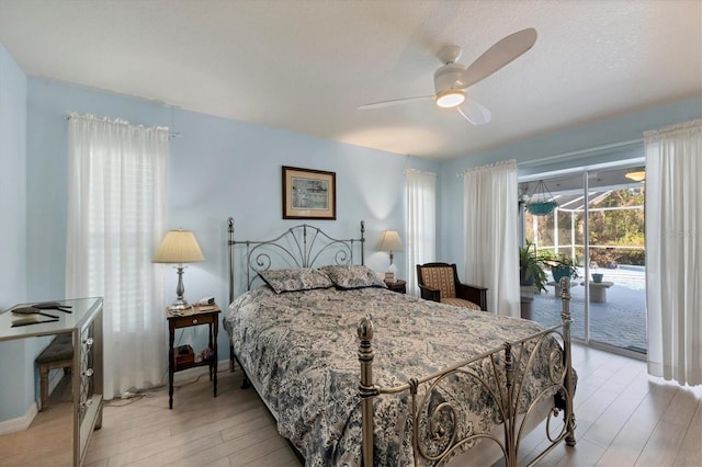 bedroom featuring ceiling fan, light hardwood / wood-style floors, and access to outside