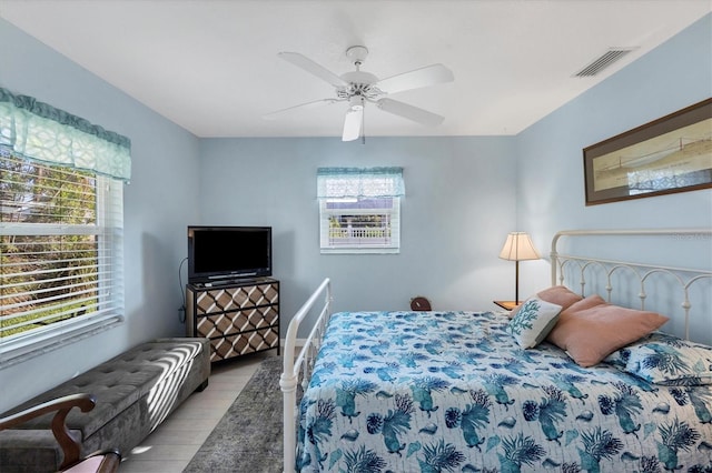 bedroom featuring multiple windows, ceiling fan, and light hardwood / wood-style floors