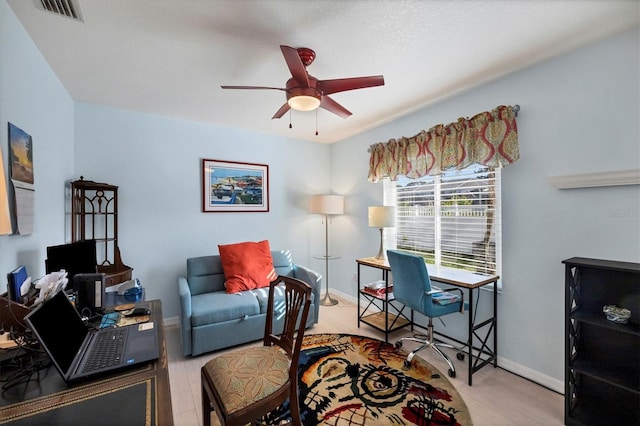 office featuring light hardwood / wood-style floors and ceiling fan