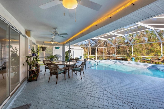 view of pool with a shed, a lanai, and a patio area