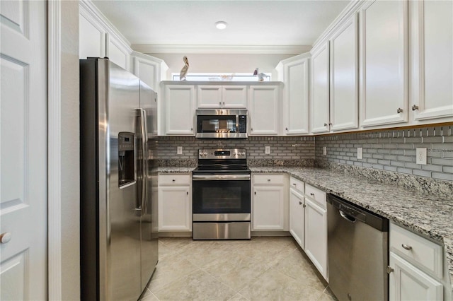 kitchen featuring white cabinets, backsplash, and appliances with stainless steel finishes