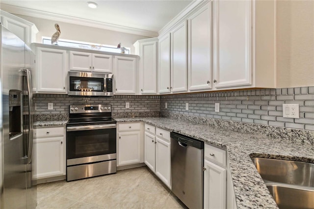 kitchen featuring decorative backsplash, white cabinetry, crown molding, and appliances with stainless steel finishes