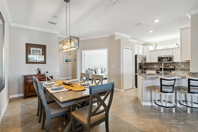 dining room with light tile patterned floors and crown molding