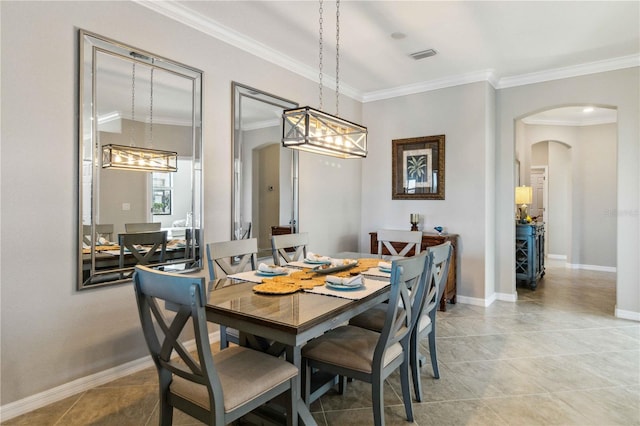 dining space with light tile patterned floors and crown molding