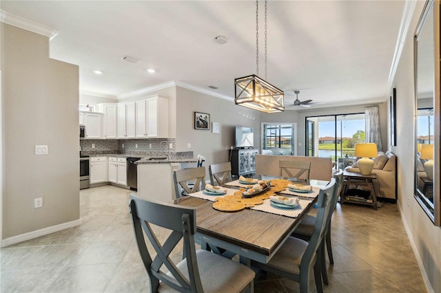 dining space featuring light tile patterned floors, ceiling fan, crown molding, and sink