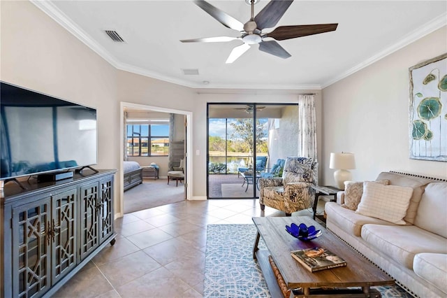 tiled living room with ceiling fan and ornamental molding