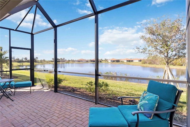 unfurnished sunroom featuring a water view