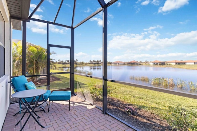 unfurnished sunroom featuring a water view