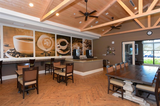 dining space with wooden ceiling, high vaulted ceiling, ceiling fan, beam ceiling, and light parquet flooring