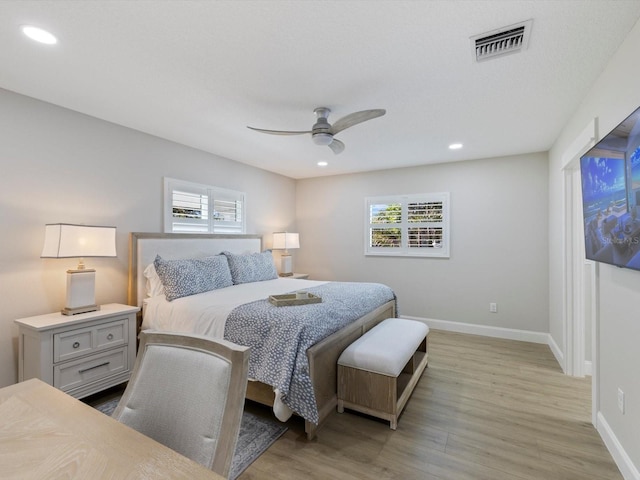 bedroom with ceiling fan and light wood-type flooring