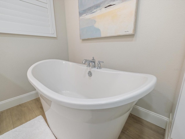 bathroom featuring a tub and wood-type flooring