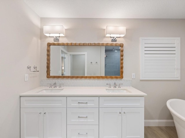 bathroom featuring vanity, wood-type flooring, a textured ceiling, and shower with separate bathtub