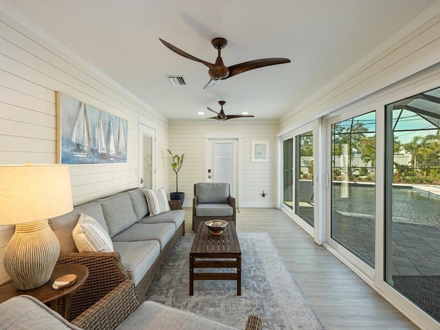 sunroom featuring ceiling fan