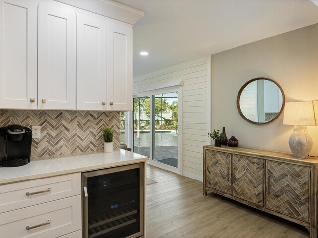842 Nokomis Ave S, Venice, FL 34285 - bar area with wine cooler, tasteful backsplash, light wood-type flooring, and recessed lighting