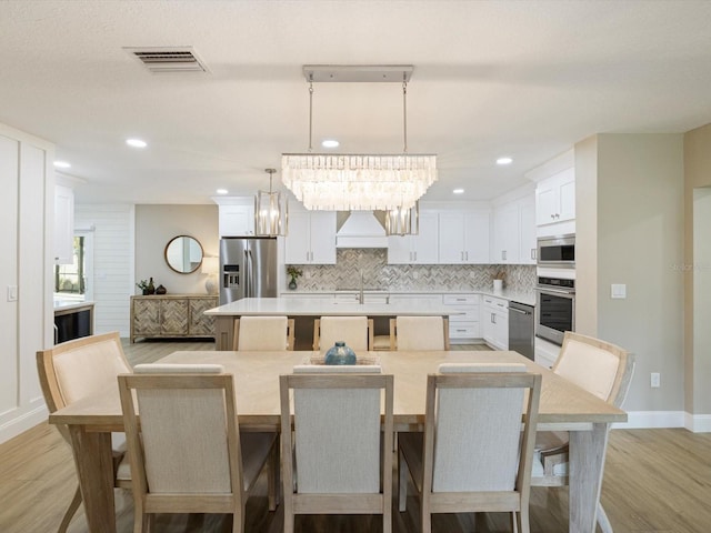 842 Nokomis Ave S, Venice, FL 34285 - dining area featuring light wood finished floors, recessed lighting, baseboards, and a chandelier