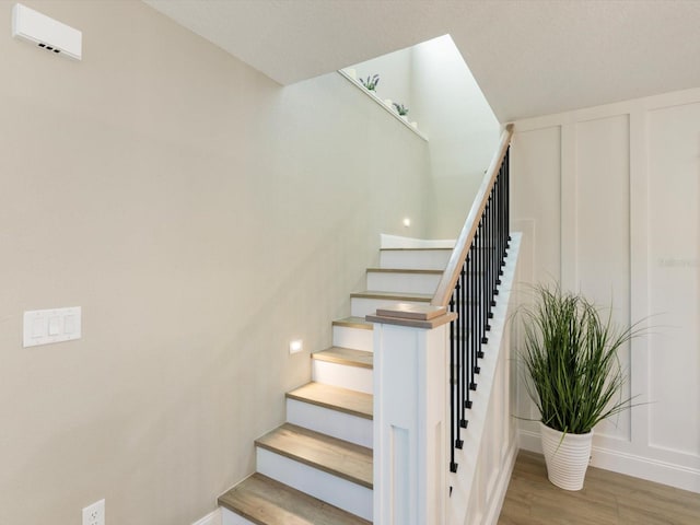 staircase with hardwood / wood-style flooring