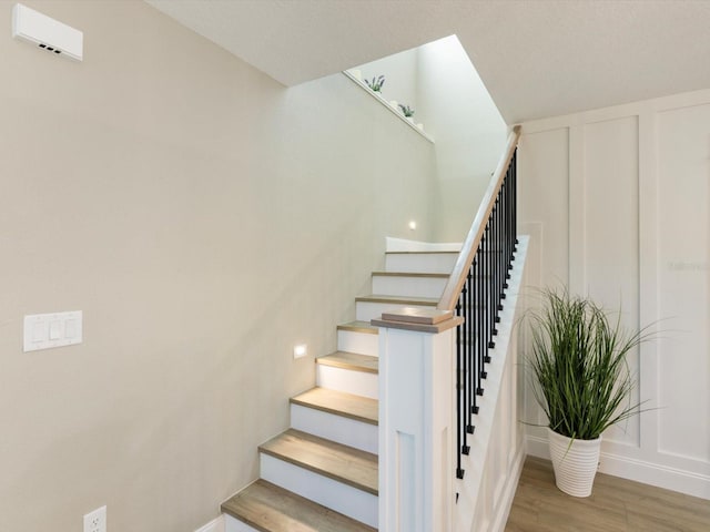 842 Nokomis Ave S, Venice, FL 34285 - staircase with wood finished floors and baseboards